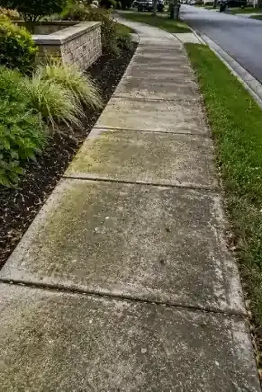 Community sidewalk with buildup before cleaning Jacksonville FL